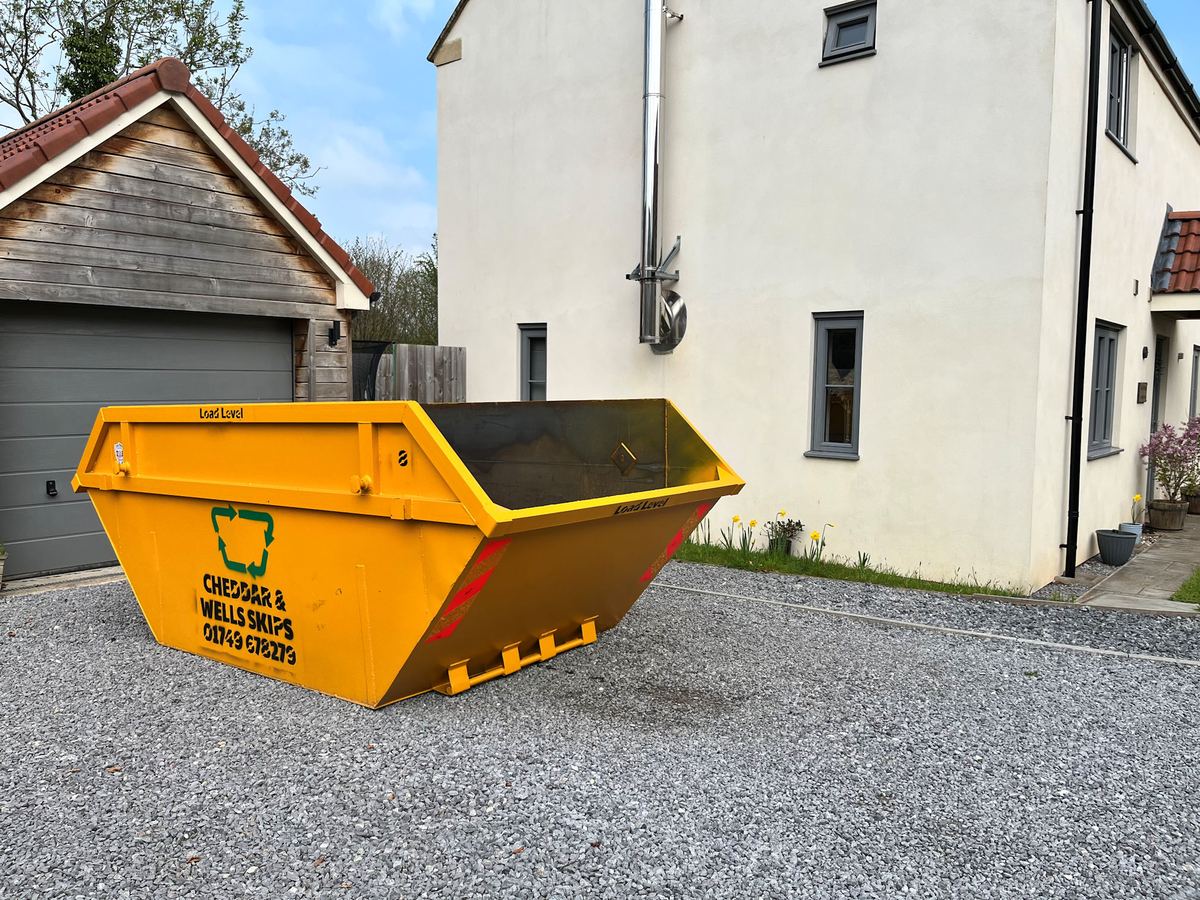 A Cheddar & Wells skip on a customer's driveway